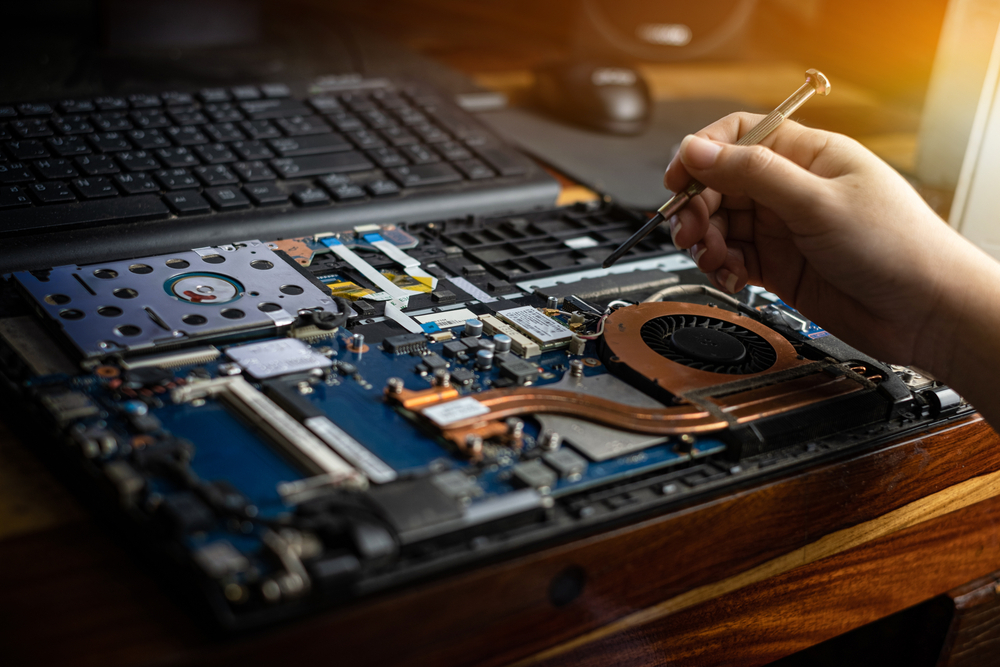 NobleTech engineer carrying out a laptop repair at the customer's location